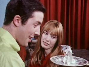 Alison (Gillian Hills) show her step-brother, Roger (Francis Wallis) a paper owl she has made by tracing and cutting out the pattern on the plates from the attic.